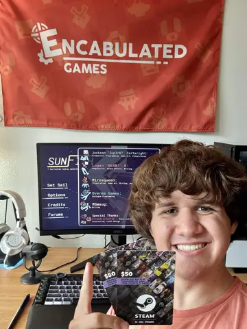 Jackson Cartwright holding two Steam gift cards, with Sunfish on the monitor behind