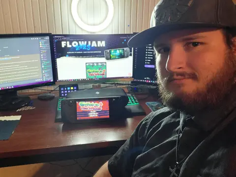 JR01 at his desk with the Steam Deck running The Witch in the Woods